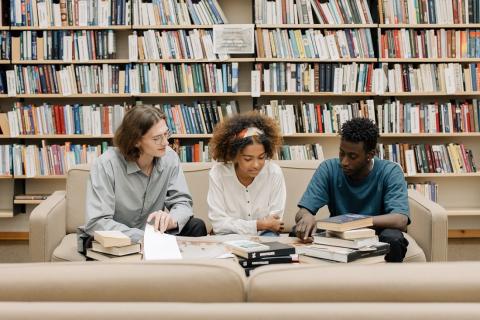 Students sitting in the library, reading books
