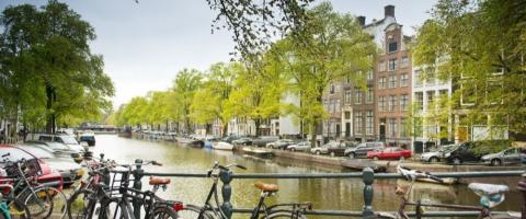 Bikes and buildings alongside the canal in Amsterdam